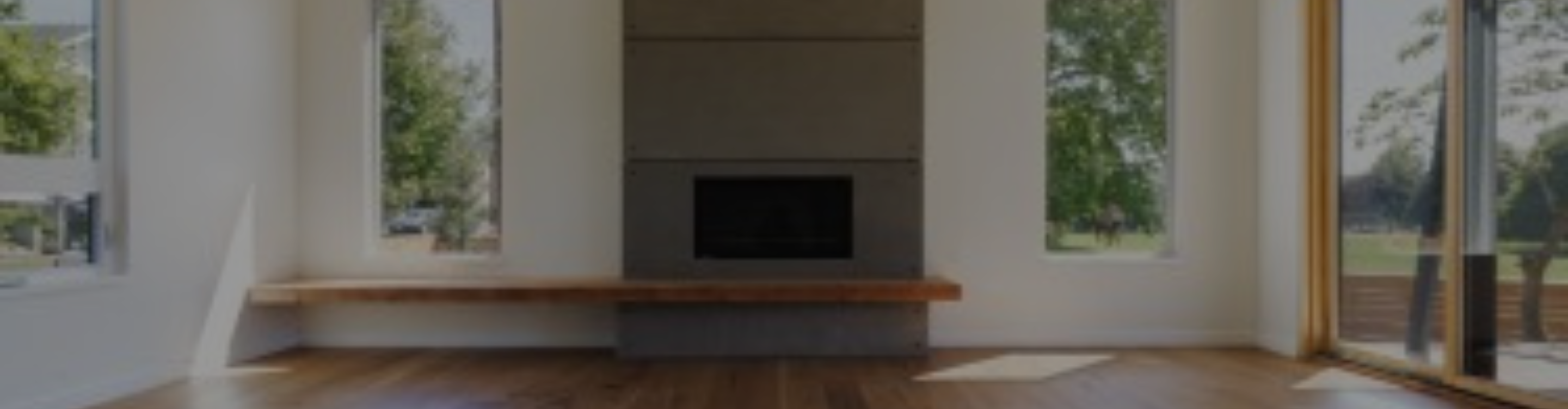 wood flooring installation in living room with floor to cieling fireplace surround
