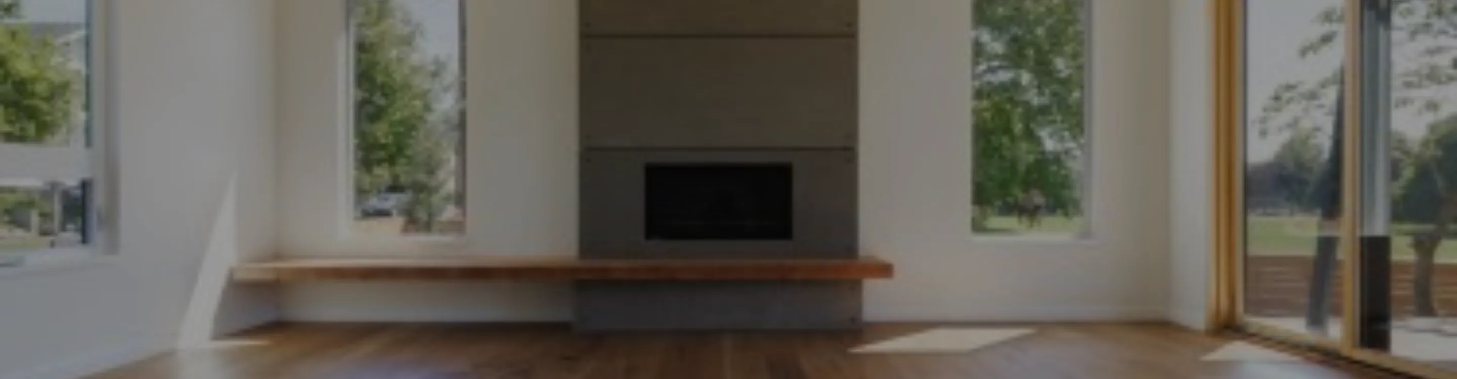 wood flooring installation in living room with floor to cieling fireplace surround